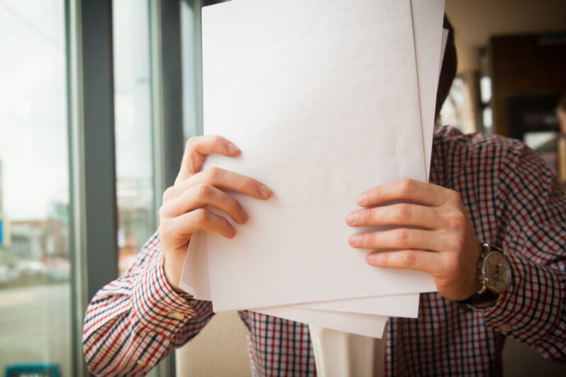 person holding white printer paper